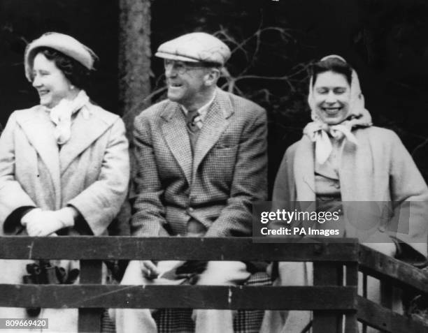 Queen Elizabeth II, the Queen Mother and the Duke of Beaufort use a farm wagon as a 'grandstand' at the Quarry Jump during the Three Day Horse Trials...