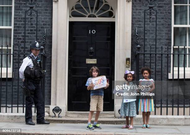 Children from the Save Our Schools campaign, Jonny Miller-cole aged 7 and Suzie and Leone Ali aged 8 deliver hand written letters to Downing Street....