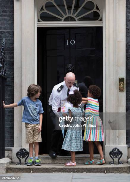 Children from the Save Our Schools campaign, Jonny Miller-cole aged 7 and Suzie and Leone Ali aged 8 deliver hand written letters to Downing Street....