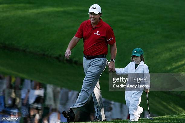 Phil Mickelson walks with his son Evan Mickelson during the Par 3 Contest at the 2008 Masters Tournament at Augusta National Golf Club on April 9,...