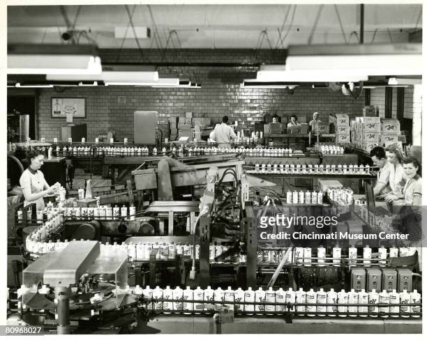 View of the Procter & Gamble production line where employees bottls Joy dish detergent, Cincinnati, Ohio, 1950s.
