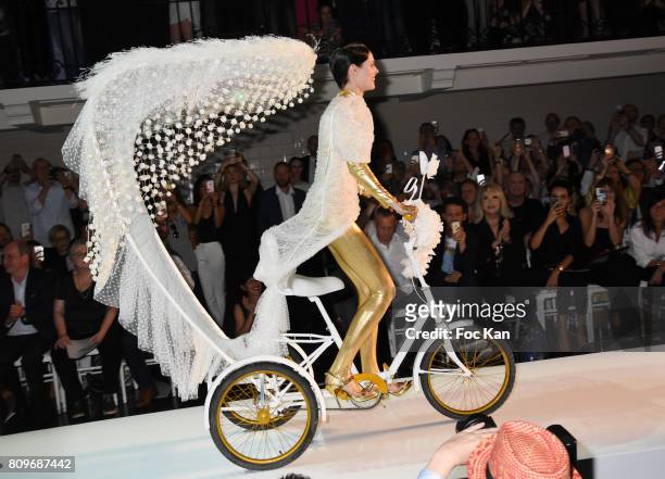 Coco Rocha drives a tricycle on the runway during the Jean Paul Gaultier Haute Couture Fall/Winter 2017-2018 show as part of Haute Couture Paris...