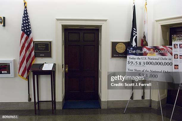 Sign-in book and a poster tallying the national debt outside the door of the office of Rep. Jim Costa, D-Calif, in the hallway on the third floor of...
