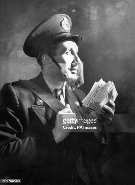Postman Robert Baker tests a new featherweight open-top smog mask. At the bottom of the mask is a small plastic tube that releases small amounts of...