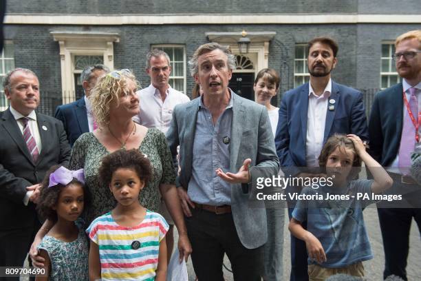 Steve Coogan talks to the media as Suzie Ali, Leonie Ali, Save Our Schools campaign co founder Alison Ali and Johnny Miller-Cole watch after...