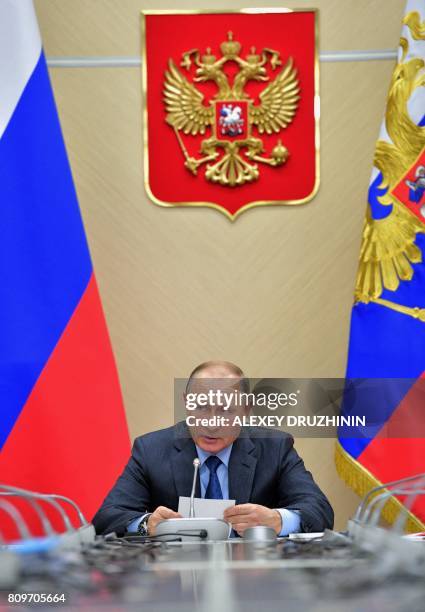 Russian President Vladimir Putin chairs the Commission on military-technical cooperation with foreign states in his residence in Novo-Ogaryovo,...