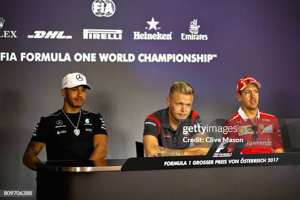 Lewis Hamilton of Great Britain and Mercedes GP, Kevin Magnussen of Denmark and Haas F1 and Sebastian Vettel of Germany and Ferrari in the Drivers...