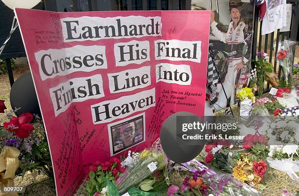 Homemade card sits among flowers at at a makeshift memorial for NASCAR driver Dale Earnhardt, February 21, 2001 at Atlanta Motor Speedway in Hampton,...