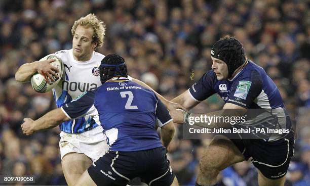 Leinster's Richardt Strauss and Mike Ross tackle Bath's Nick Abendanon during the Heineken Cup match at the Aviva Stadium, Dublin, Ireland.