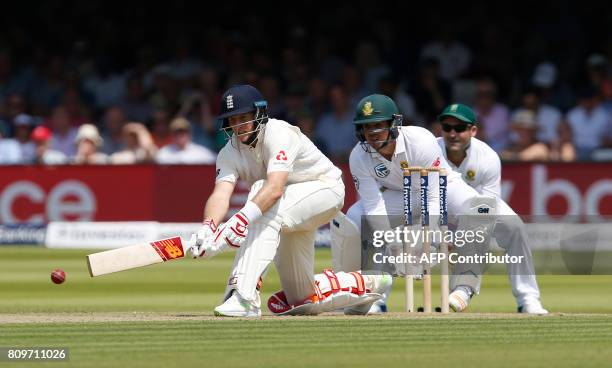 England's Captain Joe Root hits a reverse sweep shot watched by South Africa's wicketkeeper Quinton de Kock on the first day of the first Test match...