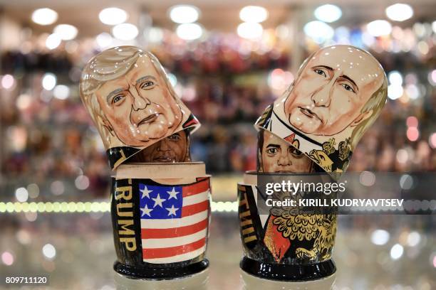 This picture taken on July 6 shows traditional Russian wooden nesting dolls, called Matryoshka dolls, depicting US President Donald Trump and...