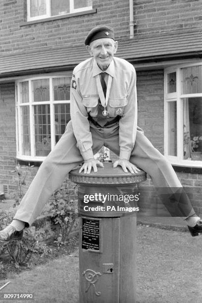Life long scout, 79 year-old George Corner, jumps over his personal pillar-box in the garden of his home in Batley, West Yorkshire. He bought the box...