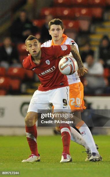 Blackpool's Craig Cathcart and Barnsley's Craig Davies battle for the ball during the npower Football League Championship match at the Oakwell...