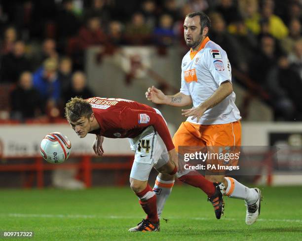 Blackpool's Gary Taylor-Fletcher is beaten to the ball by Barnsley's Scott Wiseman during the npower Football League Championship match at the...