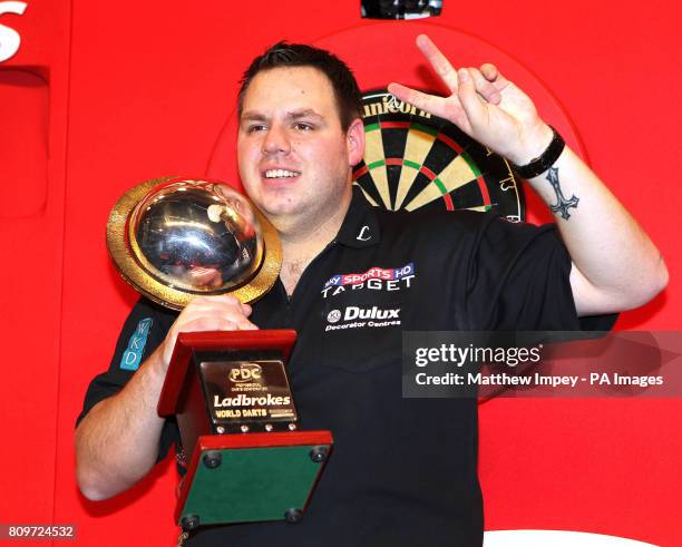 Adrian Lewis celebrates with his trophy after defeating Andy Hamilton during the Ladbrokes.com World Darts Championship Final at Alexandra Palace,...