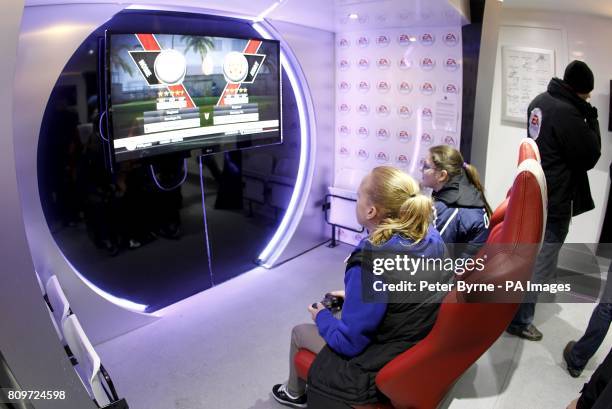 Fans play on FIFA 12 in the EA Sports dugout.