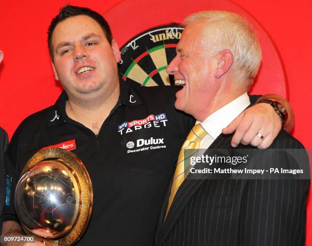 Adrian Lewis celebrates with PDC chairman Barry Hearn after defeating Andy Hamilton during the Ladbrokes.com World Darts Championship Final at...