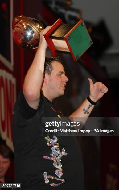 Adrian Lewis celebrates with his trophy after defeating Andy Hamilton during the Ladbrokes.com World Darts Championship Final at Alexandra Palace,...