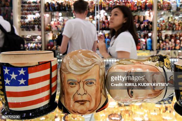This picture taken on July 6 shows traditional Russian wooden nesting dolls, called Matryoshka dolls, depicting US President Donald Trump and...