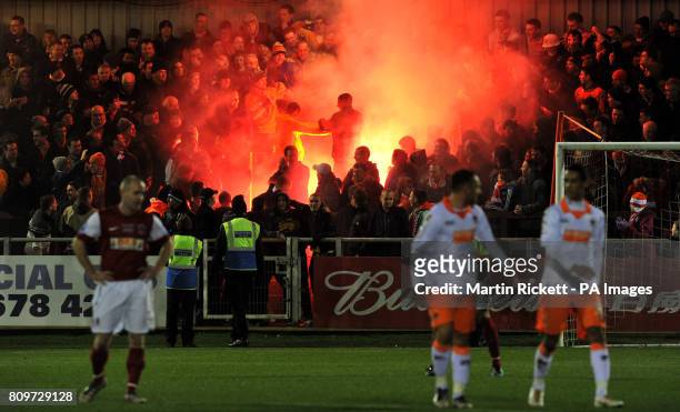 Flare in the stands as Blackpool fans celebrate their teams fouth goal during the FA Cup, Third Round match at Highbury Stadium, Fleetwood.