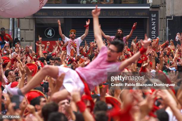 Revellers enjoy the atmosphere during the opening day or 'Chupinazo' of the San Fermin Running of the Bulls fiesta on July 6, 2017 in Pamplona,...