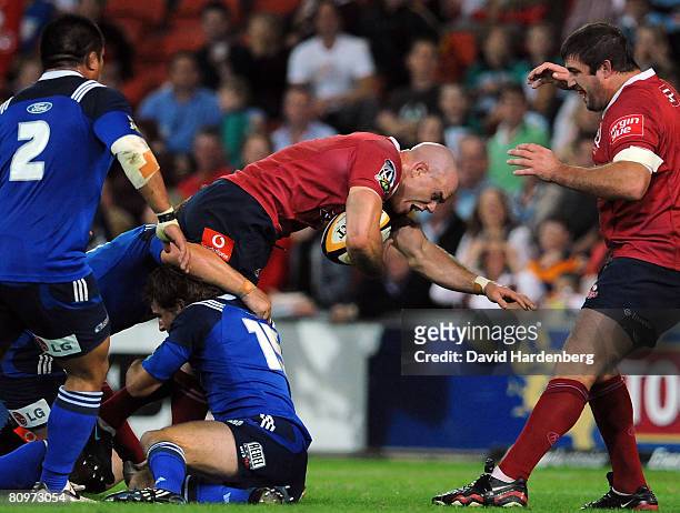 David Croft of the Reds breaks through the Blues defence to score during the round 12 Super 14 match between the Queensland Reds and the Blues at...