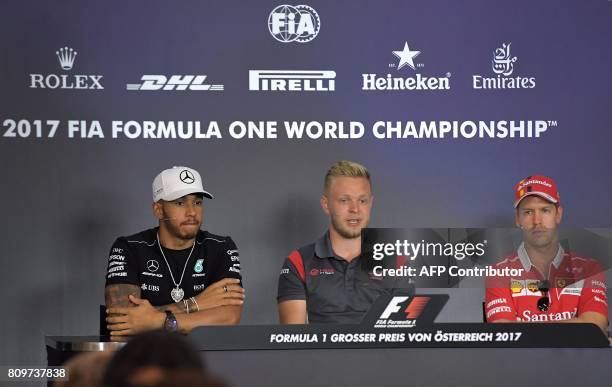 Mercedes' British driver Lewis Hamilton, Haas F1's Danish driver Kevin Magnussen and Ferrari's German driver Sebastian Vettel attend a driver's press...