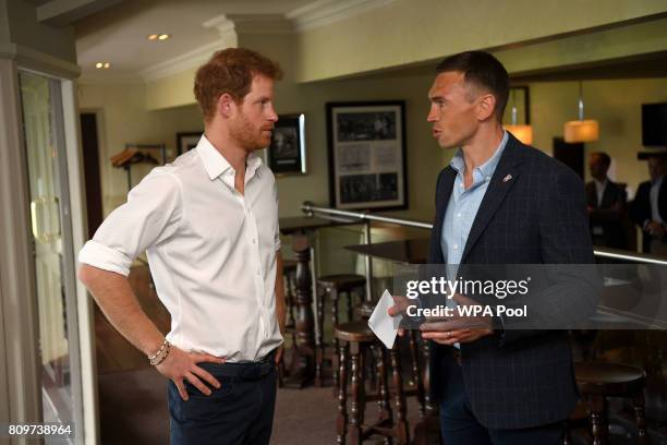 Britain's Prince Harry meets former Leeds Rhino rugby league player, Kevin Sinfield during his visit to the Headingley Carnegie Stadium on the first...