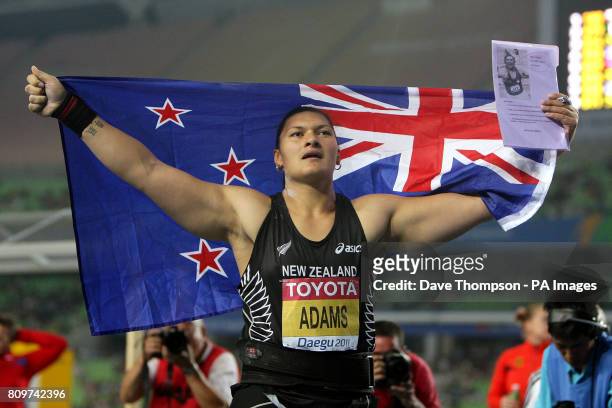New Zealand's Valeria Adams celebrates winning the Women's Shot Put Final with a sheet of recommendation from a coach