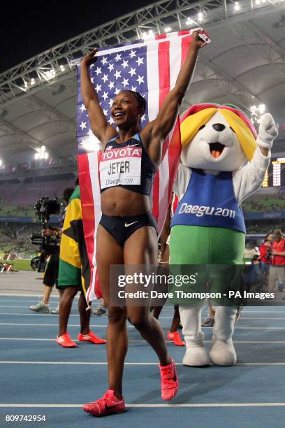 S Carmelita Jeter celebrates winning the Women's 100m Final