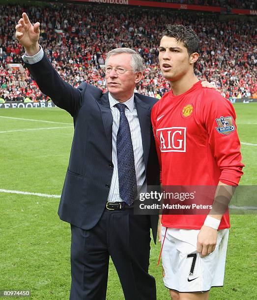 Sir Alex Ferguson and Cristiano Ronaldo of Manchester United salute the crowd after the Barclays FA Premier League match between Manchester United...