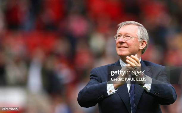 Manchester United manager Sir Alex Ferguson applauds supporters after their English Premier League football match against West Ham United at Old...