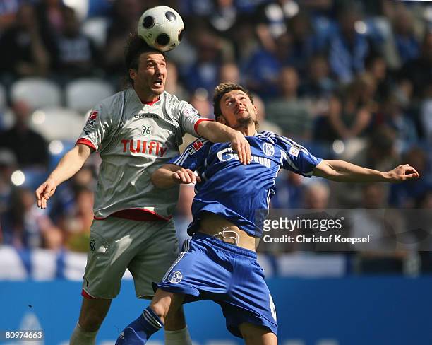 Christian Schulz of Hannover battles for the ball with Albert Streit during the Bundesliga match between Schalke 04 and Hannover 96 at the Veltins...