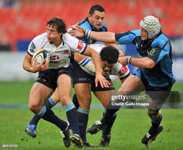 Luke Burgess of Waratahs gets away from Wikus van Heerden of Blue Bulls during the Super 14 match between Vodacom Blue Bulls and Waratahs at Loftus...