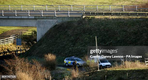 Police attend the scene near to where a car was found in a river near Holehouse Road in East Renfrewshire, Scotland, following the recovery of a body...