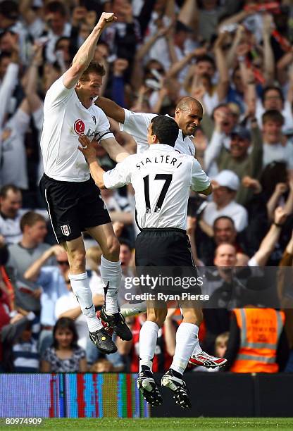 Brian McBride of Fulham celebrates with his team mates after he scored the first goal during the Barclays Premier League match between Fulham and...