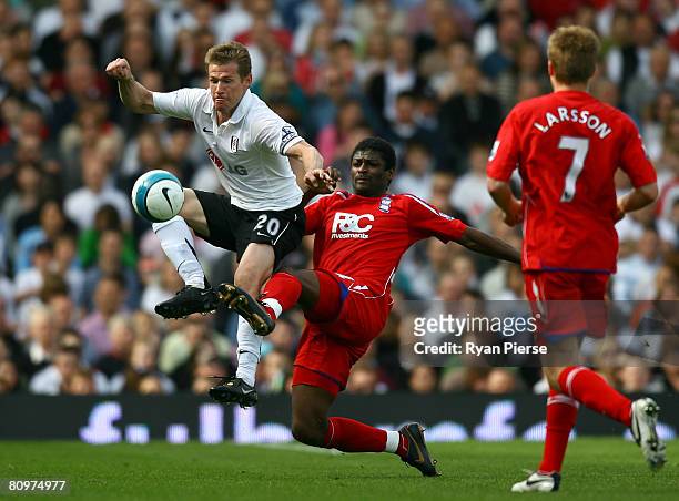 Radhi Jaidi of Birmingham City competes for the ball with Brian McBride of Fulham during the Barclays Premier League match between Fulham and...