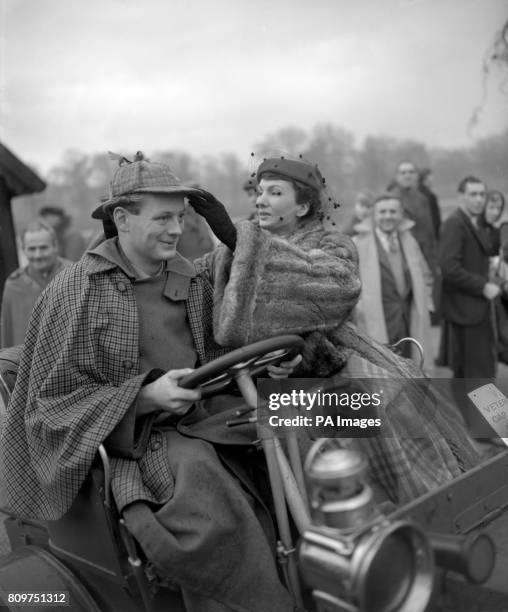 ** Fashion model Barbara Goalen gives the correct angle to the old-fashioned deer-stalker worn by Lord Montagu of Beaulieu, driving his 1902 De Dion...