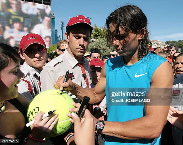 Spanish Rafael Nadal signs authographs to his fans during the semifinal match in the Barcelona Open tennis tournament Conde de Godo on May 3, 2008 in...