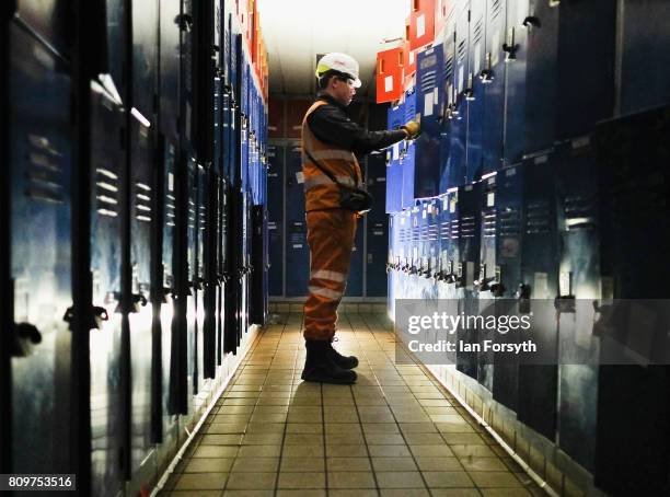 Trainee Destruct Engineer, Jack Anderson checks storage lockers in the crew area on the decommissioned Brent Delta Topside oil platform at the Able...