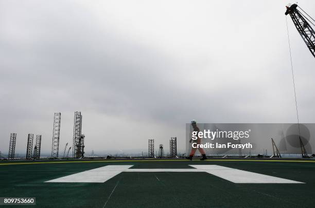 An Able UK engineer walks across the helipad onboard the decommissioned Brent Delta Topside oil platform at the Able UK site at Seaton Port on July...