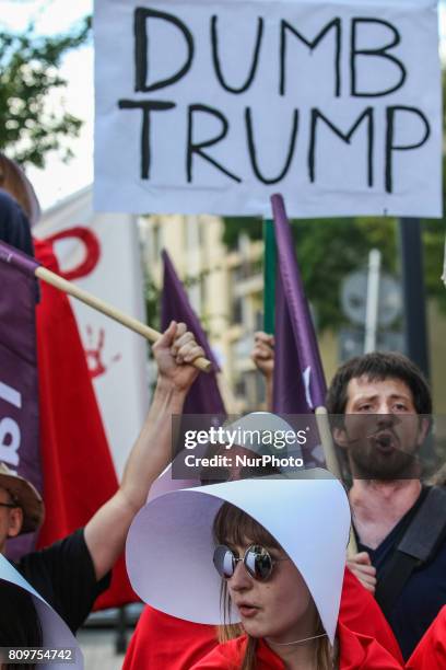 Woman dressed as as characters from The Handmaid's Tale and people holding anti-Trump posters and banners are seen in Warsaw, Poland on 6 July 2017...