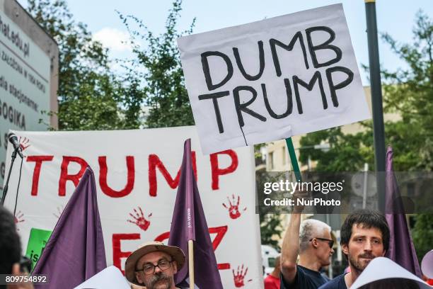 Woman dressed as as characters from The Handmaid's Tale and people holding anti-Trump posters and banners are seen in Warsaw, Poland on 6 July 2017...