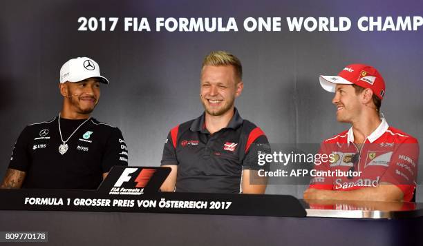Mercedes' British driver Lewis Hamilton, Haas F1's Danish driver Kevin Magnussen and Ferrari's German driver Sebastian Vettel attend a driver's press...