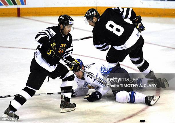 Germany's Andrea Renz and Sebastian Osterloh skate past Finland's Sean Bergenheim during the preliminary round of the 2008 IIHF World Hockey...