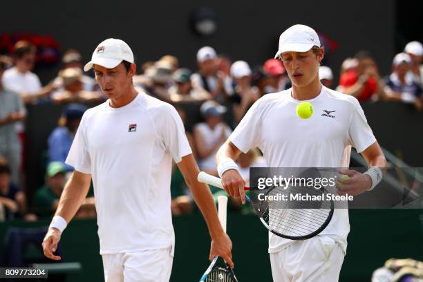 Marc Polmans of Australia and Andrew Whittington of Australia look on during the Gentlemen's Doubles first round match against Bob Bryan of the...