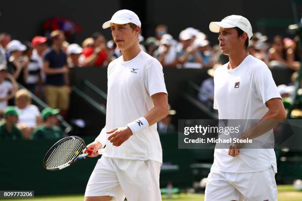 Marc Polmans of Australia and Andrew Whittington of Australia look on during the Gentlemen's Doubles first round match against Bob Bryan of the...