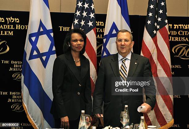 Secretary of State Condoleezza Rice stands in front of an Israeli flag while meeting Israeli Defence Minister Ehud Barak before a breakfast at the...