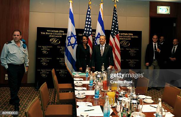 Secretary of State Condoleezza Rice stands in front of an Israeli flag while meeting Israeli Defence Minister Ehud Barak before a breakfast at the...