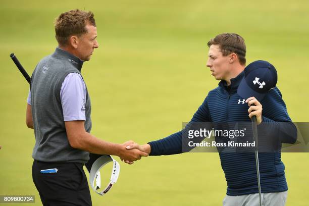 Ian Poulter of England and Matthew Fitzpatrick of England shake hands on the 18th green during day one of the Dubai Duty Free Irish Open at...